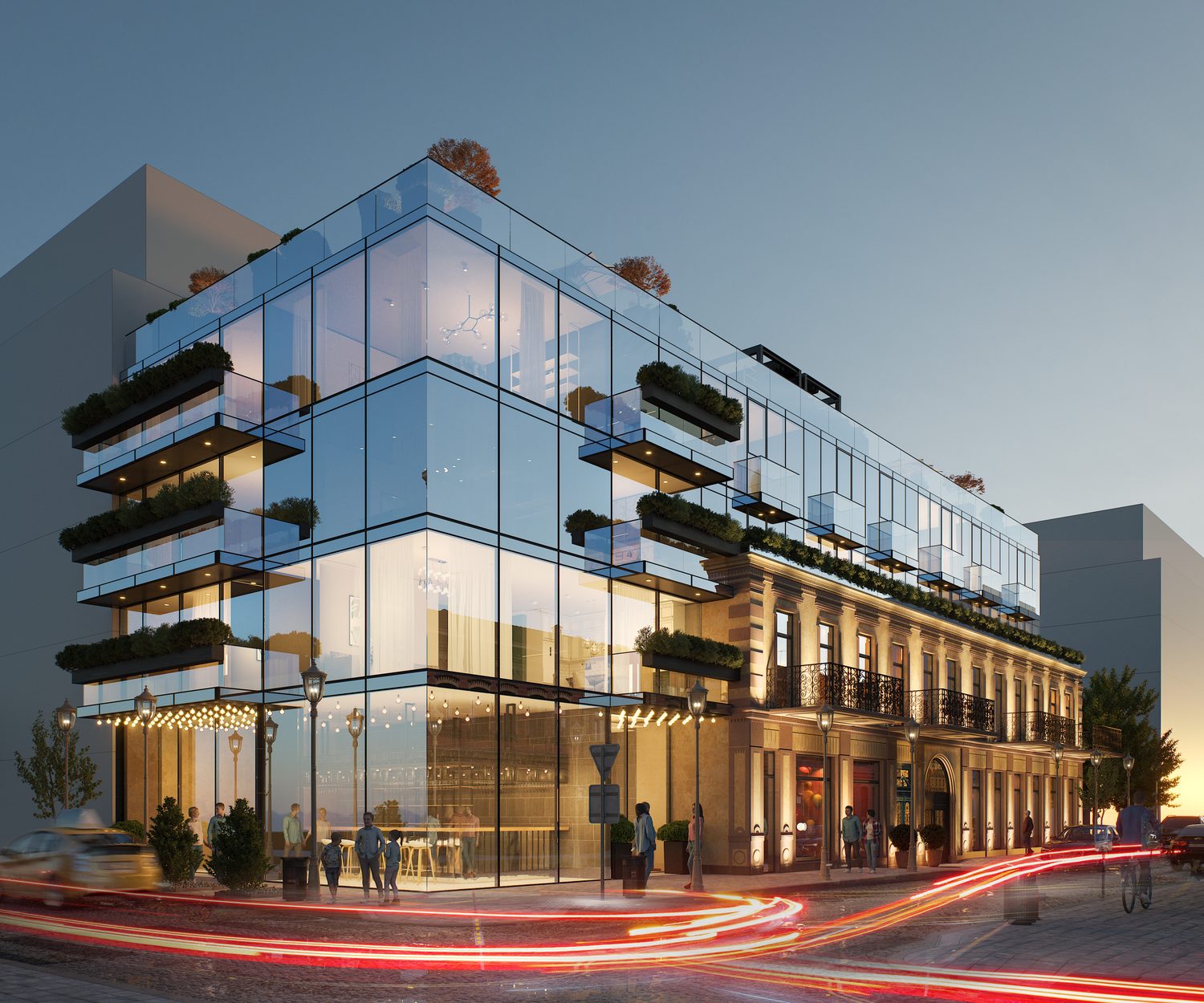 The corner at dusk and again after dark — the glass volume lit from inside, the restaurant and bar at street level.
